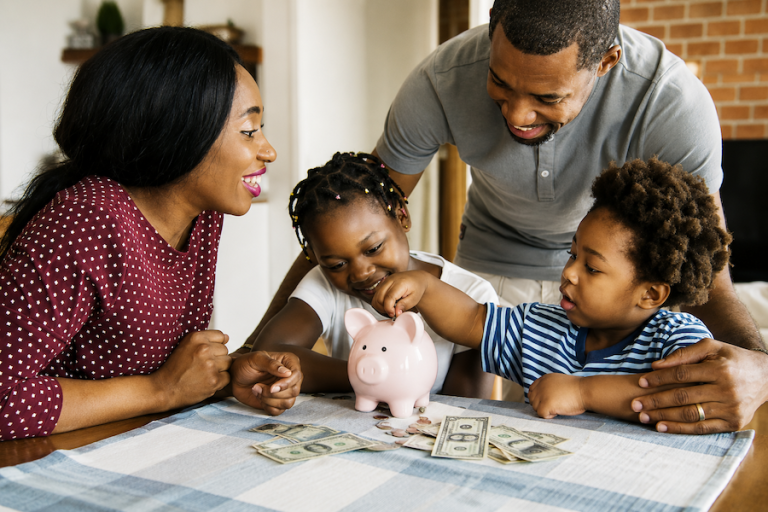 Young family enjoying time together at home at dinner table.