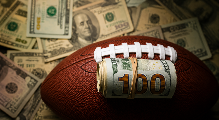 Football with money around it